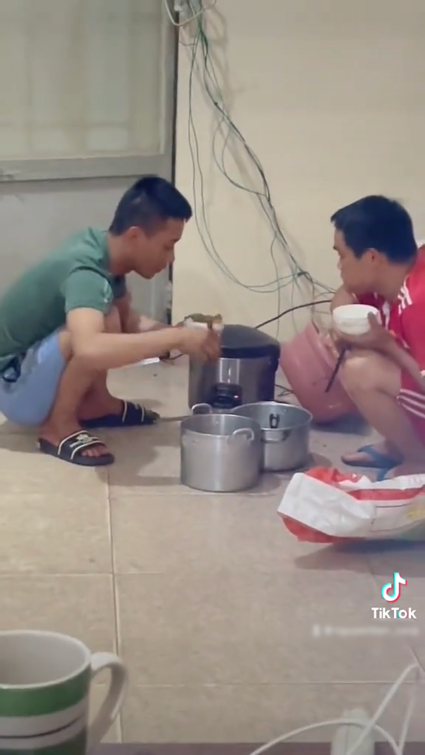  Quang Linh cùng Hùng Kaka ngồi xổm ăn tối, “chuẩn” chân chất. (Ảnh: TikTok Nguyễn Tiến)